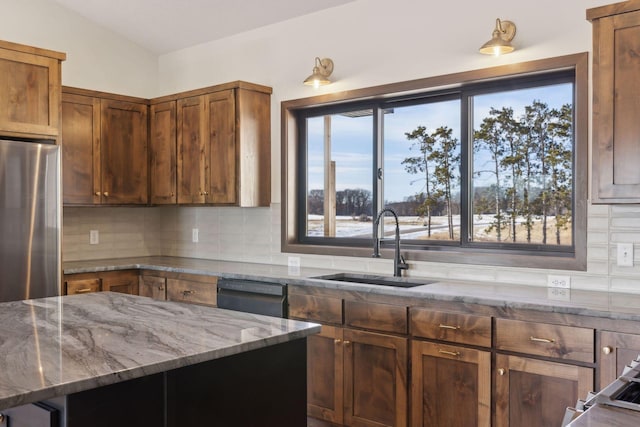 21933 Edison Ct, East Bethel, MN 55011 - kitchen with sink, stainless steel refrigerator, dishwasher, dark stone counters, and decorative backsplash