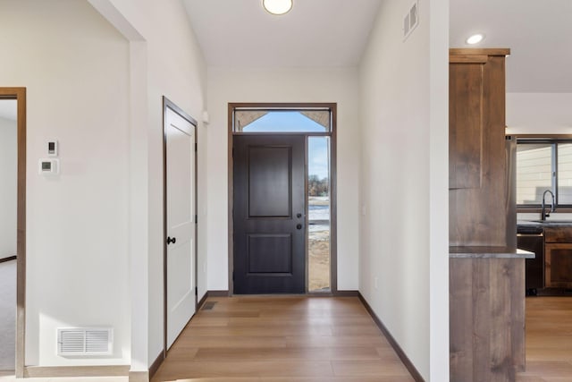21933 Edison Ct, East Bethel, MN 55011 - doorway featuring sink and light wood-type flooring