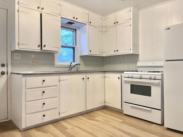 kitchen with sink, white cabinetry, white appliances, light hardwood / wood-style floors, and decorative backsplash