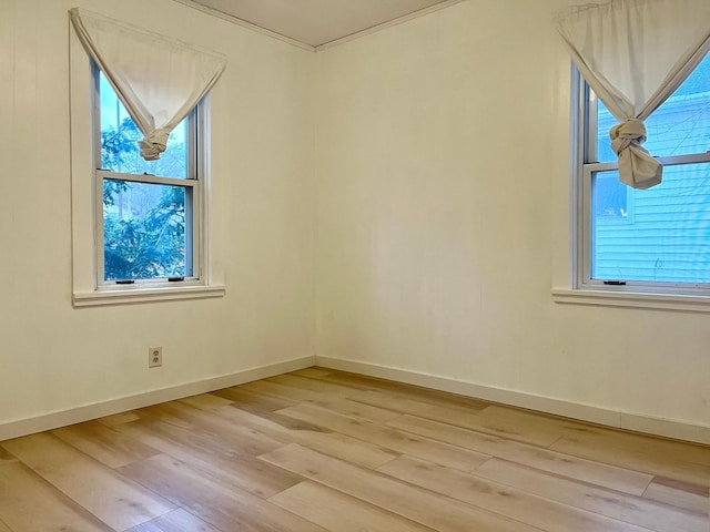 spare room with hardwood / wood-style floors and a healthy amount of sunlight