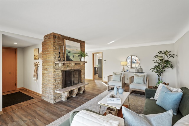 living room with hardwood / wood-style flooring and a fireplace