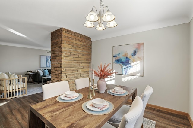 dining room featuring an inviting chandelier and dark wood-type flooring