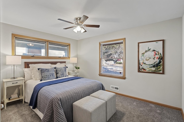 carpeted bedroom featuring ceiling fan and multiple windows