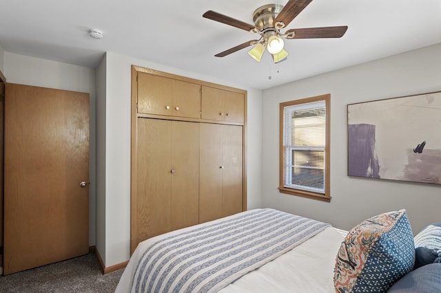 carpeted bedroom featuring ceiling fan and a closet