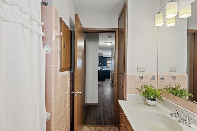 bathroom with vanity and tile walls