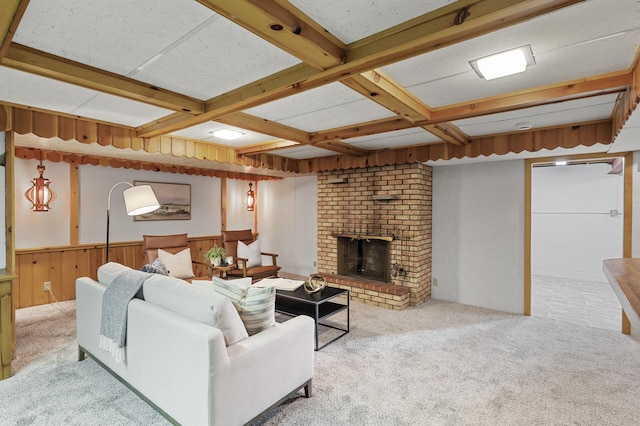 living room featuring beamed ceiling, a brick fireplace, coffered ceiling, and light colored carpet