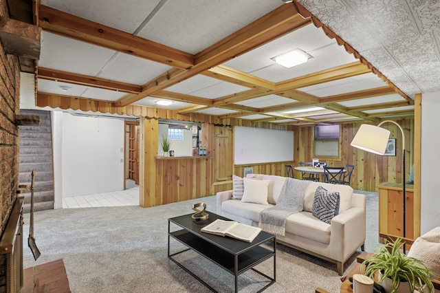 living room with coffered ceiling, beam ceiling, light carpet, and wood walls