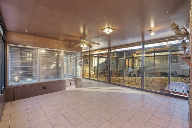 unfurnished sunroom featuring ceiling fan