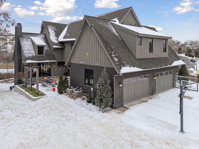 exterior space featuring a garage and central AC