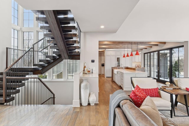 interior space featuring plenty of natural light, sink, and light wood-type flooring