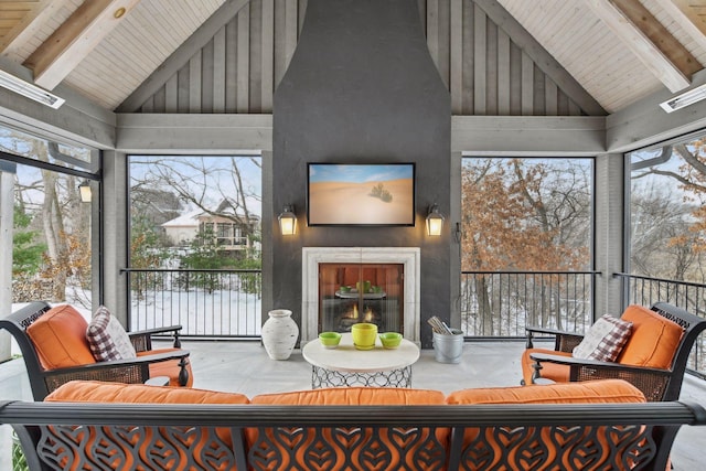 sunroom featuring vaulted ceiling with beams and wooden ceiling