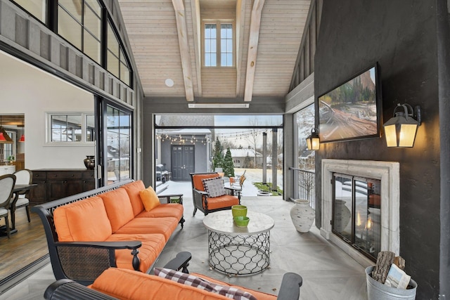 living room with beam ceiling, high vaulted ceiling, and a wealth of natural light