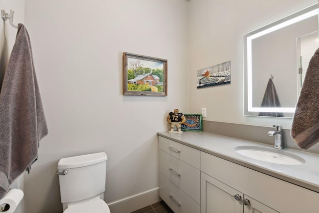 bathroom with vanity, tile patterned flooring, and toilet