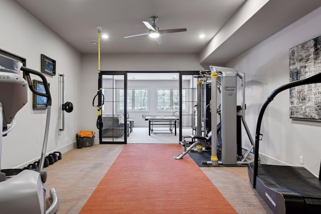 workout area featuring ceiling fan and carpet flooring