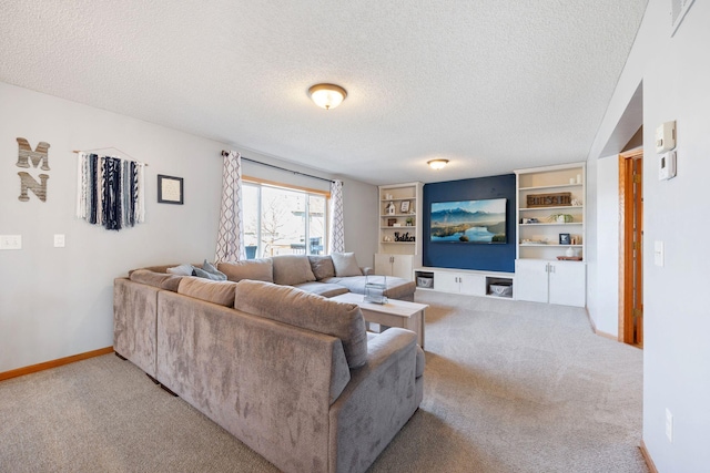 living room with built in features, baseboards, carpet, and a textured ceiling