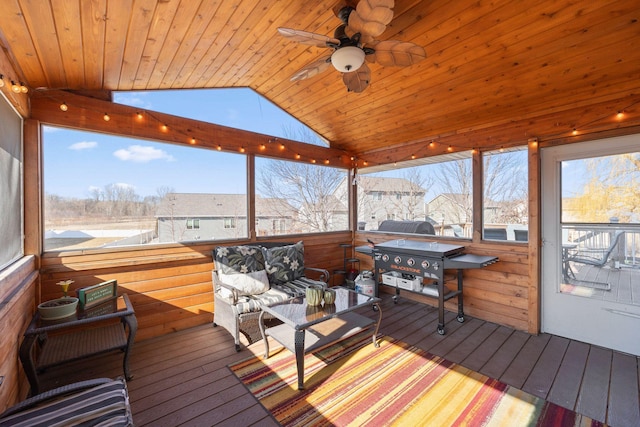 sunroom / solarium with a ceiling fan and outdoor lounge area