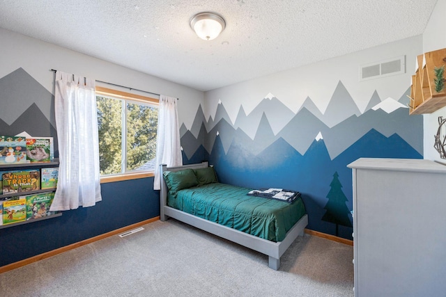 carpeted bedroom with baseboards, a textured ceiling, and visible vents