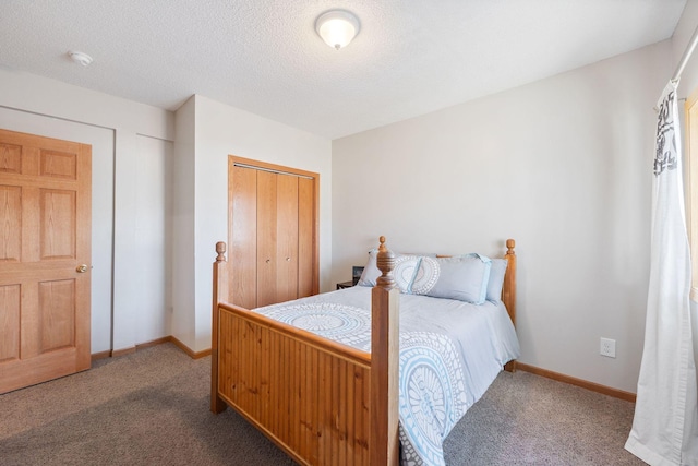 carpeted bedroom featuring baseboards, a closet, and a textured ceiling