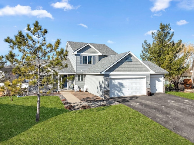 view of front of house with an attached garage, driveway, roof with shingles, and a front lawn