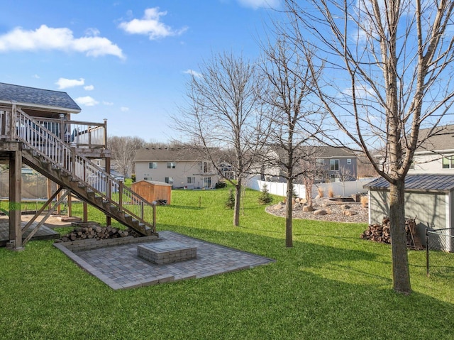 view of yard featuring a wooden deck, fence, a residential view, a patio area, and stairway