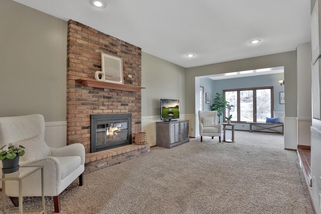 carpeted living room featuring a fireplace