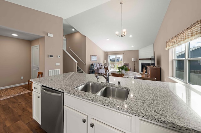 18943 Ivanhoe St NW, Elk River, MN 55330 - kitchen with open floor plan, stainless steel dishwasher, a sink, and vaulted ceiling