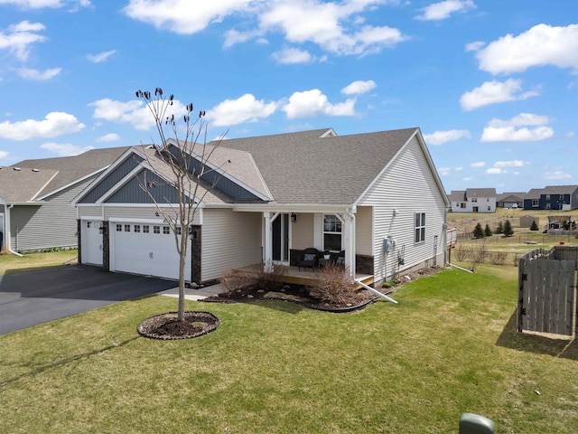 18943 Ivanhoe St NW, Elk River, MN 55330 - view of front of property with an attached garage, aphalt driveway, a shingled roof, and a front yard