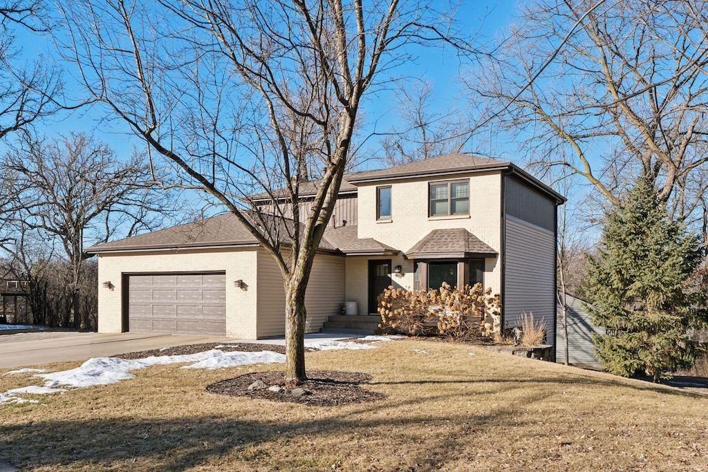 view of property with a garage and a front yard