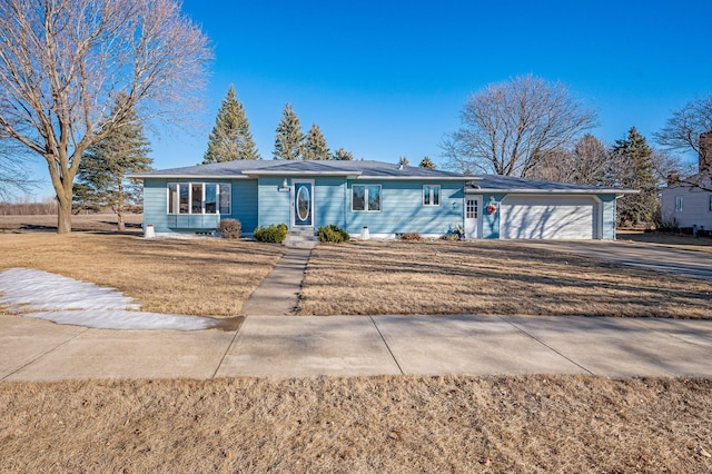 ranch-style home with a garage and a front lawn