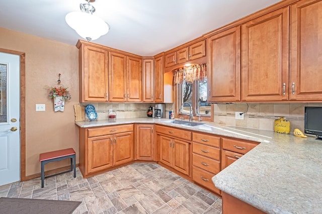 kitchen featuring tasteful backsplash and sink