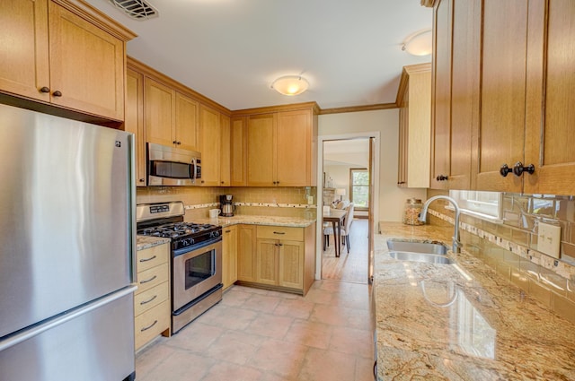 5524 Columbus Ave, Minneapolis, MN 55417 - kitchen featuring stainless steel appliances, tasteful backsplash, light stone countertops, ornamental molding, and light stone finish flooring