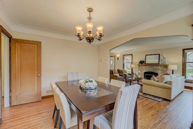 5524 Columbus Ave, Minneapolis, MN 55417 - dining area featuring arched walkways, light wood-style flooring, and healthy amount of natural light