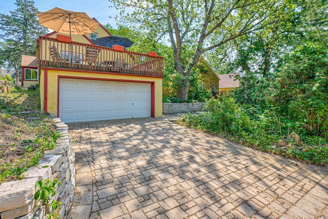 5524 Columbus Ave, Minneapolis, MN 55417 - view of front of home featuring a garage, decorative driveway, and a balcony