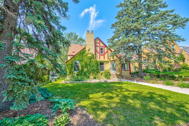 5524 Columbus Ave, Minneapolis, MN 55417 - tudor house featuring a chimney and a front yard