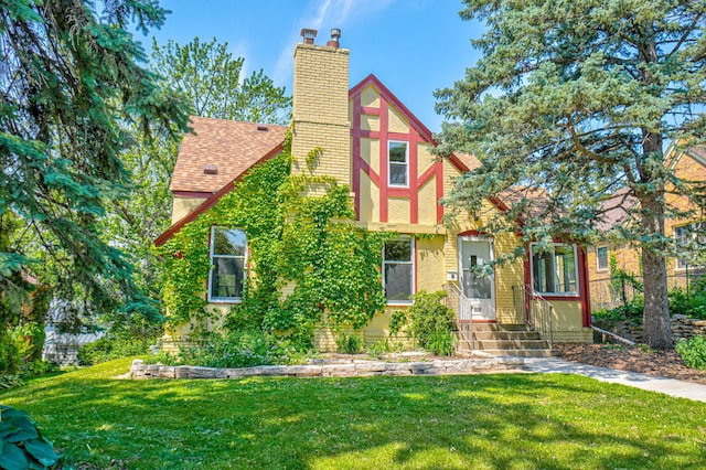 5524 Columbus Ave, Minneapolis, MN 55417 - view of front facade featuring a front yard, a chimney, and roof with shingles
