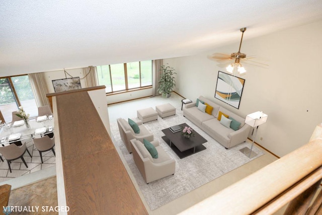 living room featuring a textured ceiling, plenty of natural light, and lofted ceiling