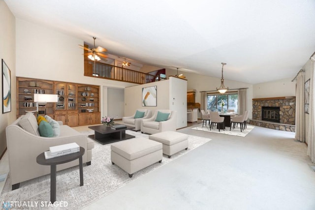 carpeted living area featuring high vaulted ceiling and a stone fireplace