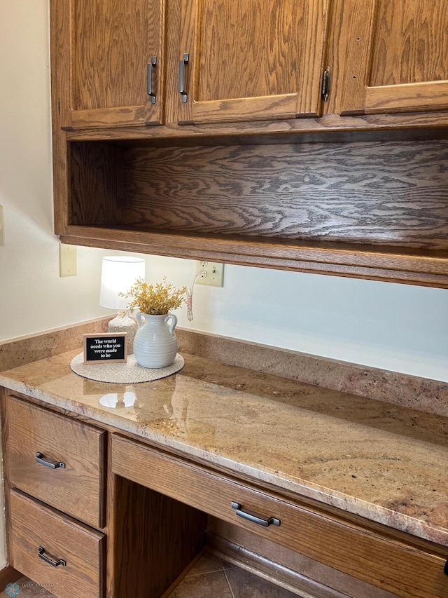 kitchen with brown cabinets and light stone countertops