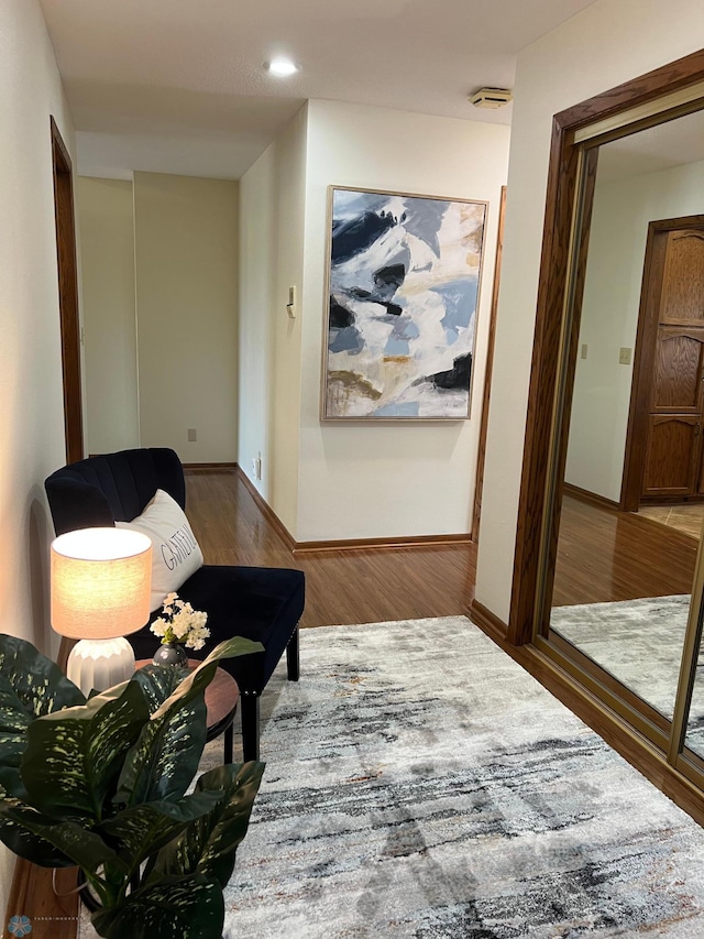 hall featuring baseboards and wood finished floors