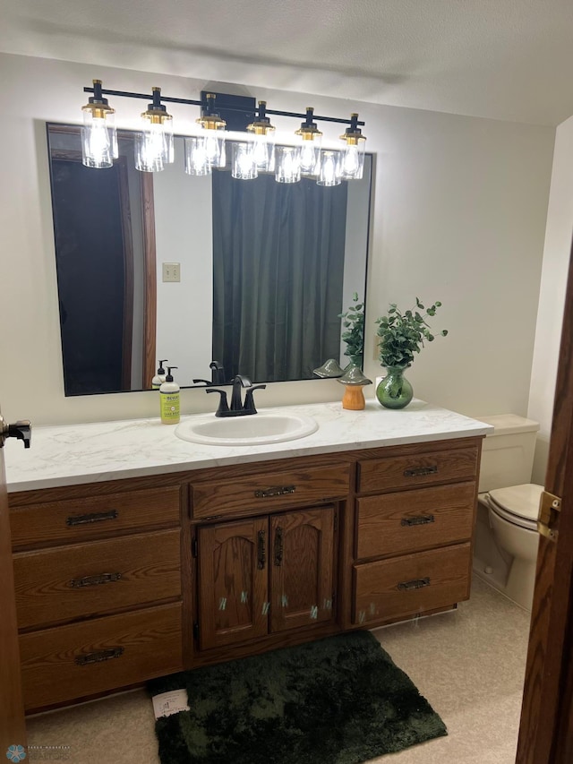 bathroom with toilet and vanity