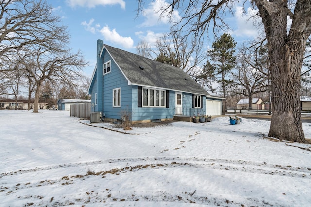 view of front of home with a garage and cooling unit