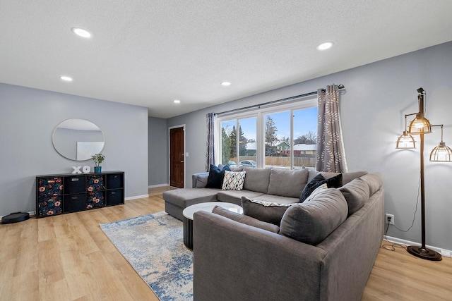 living room with hardwood / wood-style floors and a textured ceiling