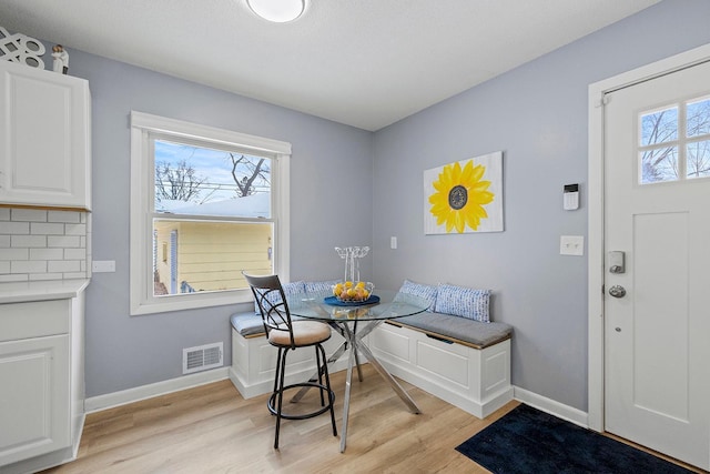 dining area featuring a healthy amount of sunlight, light hardwood / wood-style floors, and breakfast area