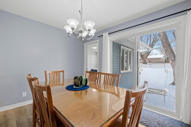 dining room featuring hardwood / wood-style floors and a notable chandelier