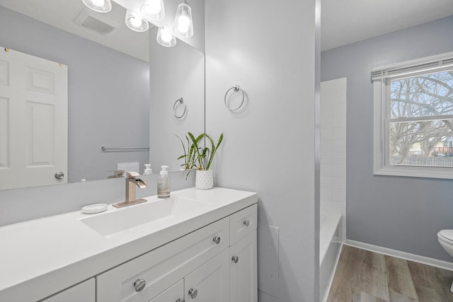 full bathroom with vanity, toilet, shower / bath combination, and wood-type flooring