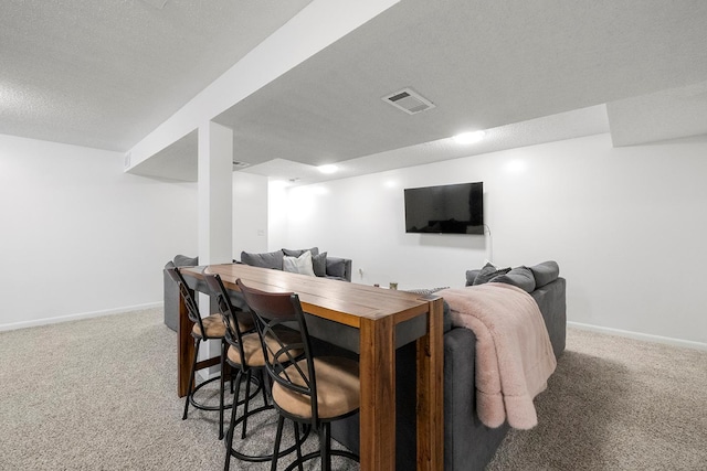 interior space with carpet floors and a textured ceiling