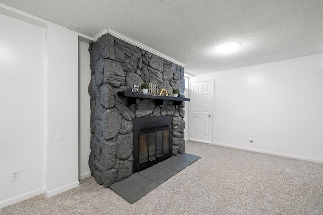 carpeted living room featuring a stone fireplace and a textured ceiling