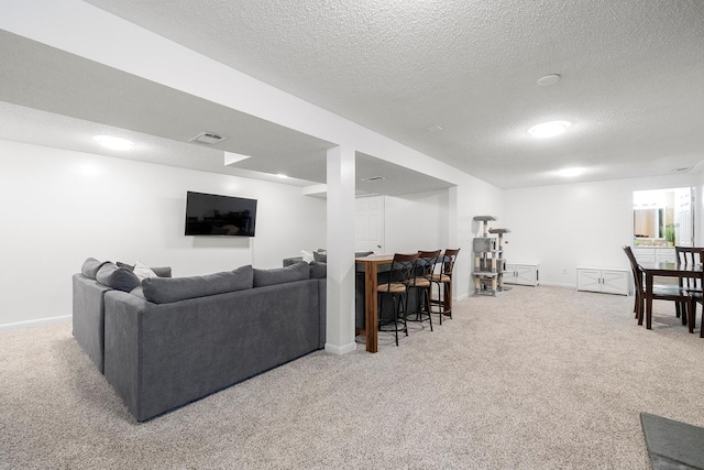 living room featuring light colored carpet and a textured ceiling