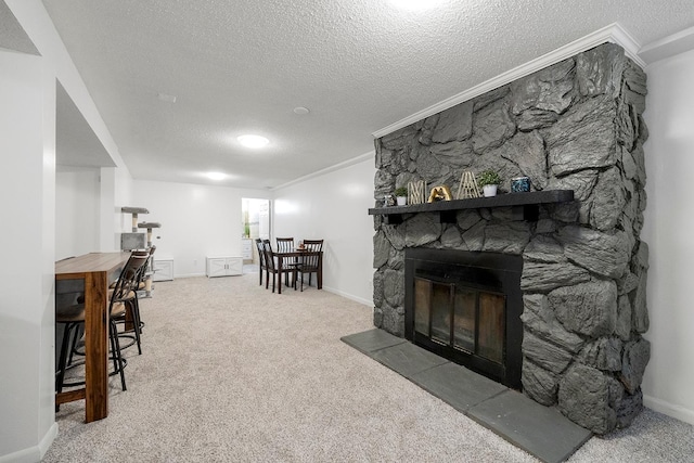 carpeted living room featuring crown molding, a stone fireplace, and a textured ceiling