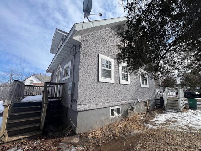view of home's exterior with a wooden deck